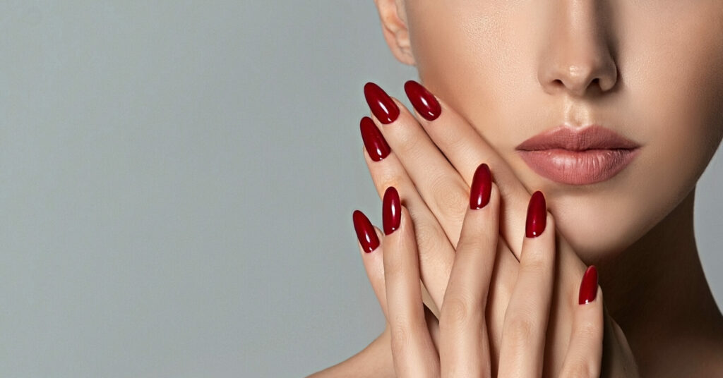 Lady with red nails against face